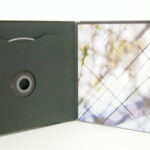 Custom cd jacket oversized with swinging sleeve black paper die cut center hole and inner pages