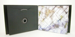 Custom cd jacket oversized with swinging sleeve black paper die cut center hole and inner pages