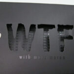 Die cut lettering WTF on slipcase showing spot gloss ink underneath