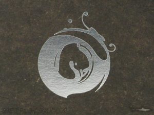 Silver foil on fiberboard black print