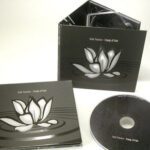 Spot gloss ink ripples and lotus in matte lam pond 6pp digipak, metallic ink inside